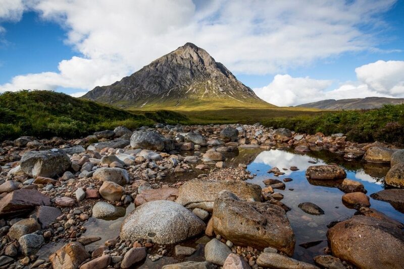 Buachaille Etive Mòr rises above a rocky riverbed in Glen Coe