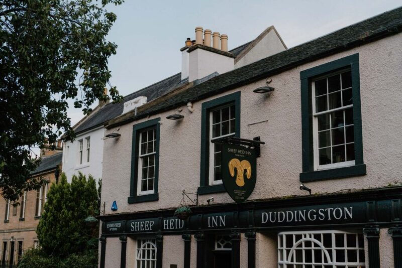 White-washed Sheep Heid Inn Duddingston with black-framed windows and a ram's head sign