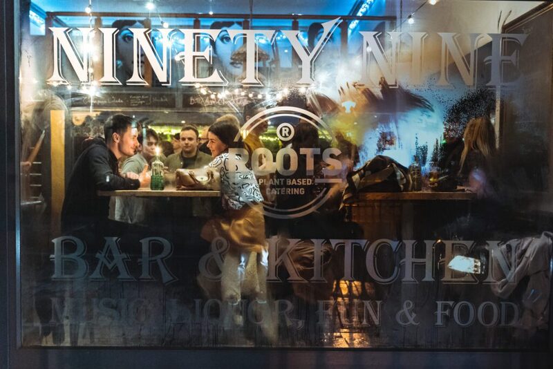 Ninety Nine Bar & Kitchen window, reflections of people at the counter inside