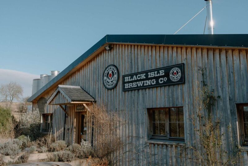 Corrugated metal building with Black Isle Brewing Co sign and porch entrance