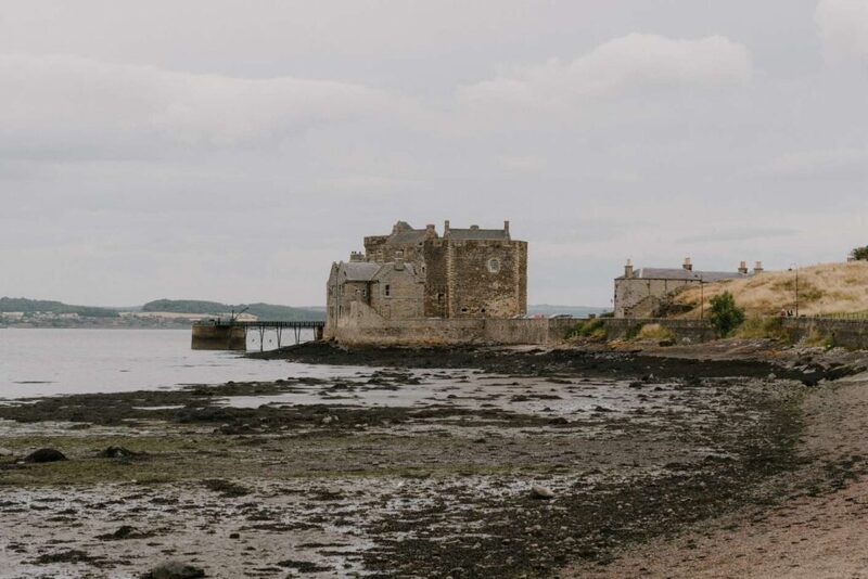 Blackness Castle stands on the Firth of Forth shoreline at low tide