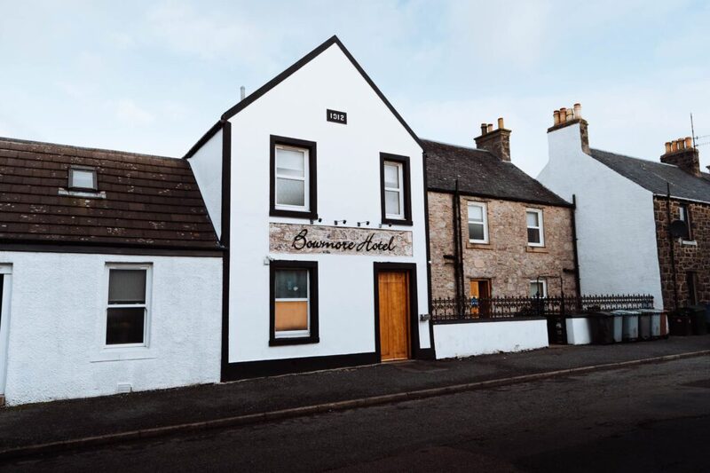 The whitewashed front of the Bowmore Hotel on Jamieson Street, its name across the gable.